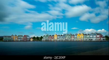 Houten, Netherlands - 9 June, 2022: panorama view of the colorful rainbow houses and lake in Houten Stock Photo