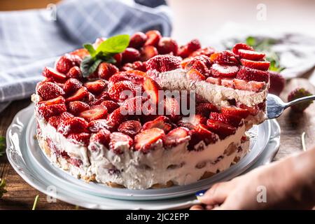 Woman's hand slices strawberry cream pie - Close up Stock Photo - Alamy