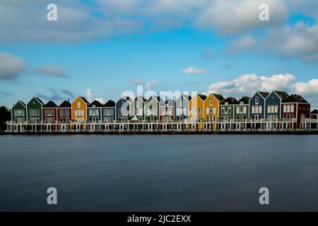 Houten, Netherlands - 9 June, 2022: long exposure view of the colorful rainbow houses and lake in Houten Stock Photo