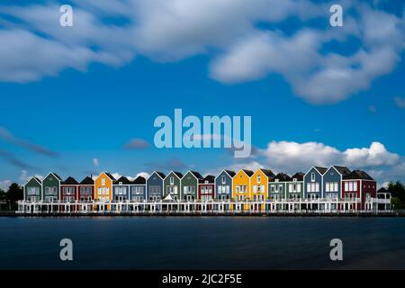 Houten, Netherlands - 9 June, 2022: long exposure view of the colorful rainbow houses and lake in Houten Stock Photo