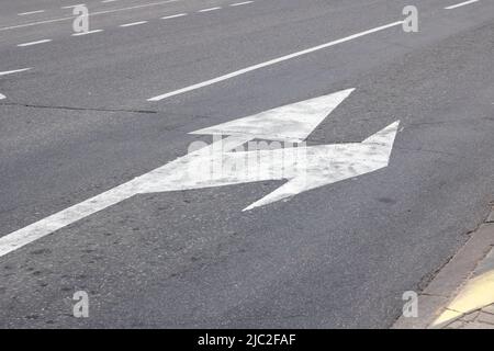 Marking of the arrow pointer on the asphalt road close up Stock Photo