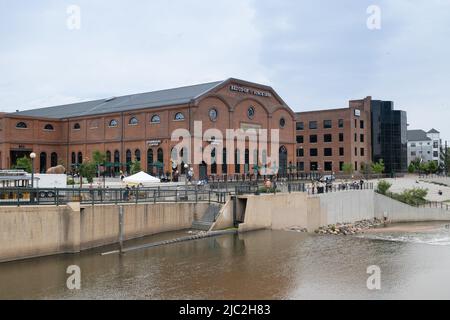 Denver, Colorado, May 28, 2022. Side View of the REI historical building, the public walking and biking on the South Platter River Trail Stock Photo