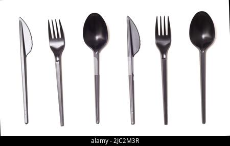 Repeating black plastic disposable knife,spoon and fork isolated on white, top view Stock Photo