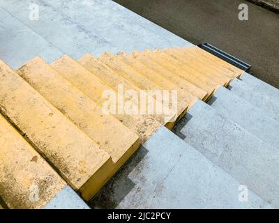 Concrete staircase. Yellow colored minimalist stairs in perspective Stock Photo
