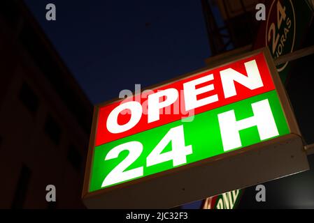 Close-up of Open 24 Hours signboard  at dusk- stock photo Stock Photo