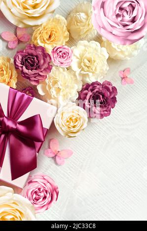Colorful roses and gift box on white background. Beautiful, good for holidays and gift. Flowers pattern. Stock Photo