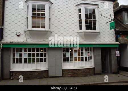 TOTNES, UK - JUNE 26, 2021 branch of Specsavers optician on Fore Street on a cloudy day Stock Photo