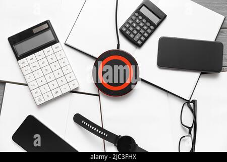 Wireless charger pad, gadgets and calculators on table Stock Photo