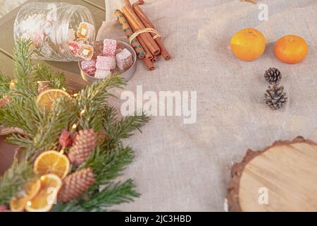 Christmas decor of table natural spruce wreath on a fabric tablecloth Stock Photo