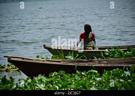 lady setting on wooden boat Stock Photo