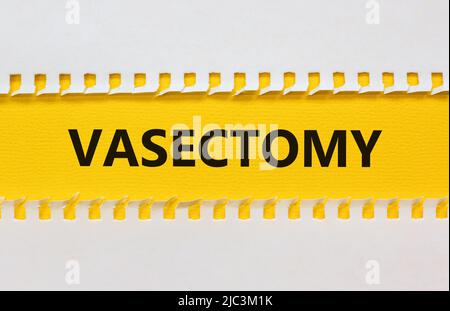 Vasectomy symbol. Concept words Vasectomy on yellow and white paper. Beautiful white background. Medical and vasectomy problem concept. Conceptual ima Stock Photo