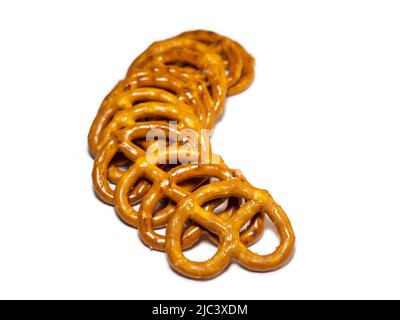 Small pretzels on a white background. Flour products are in a row. Baking for tea. Crispy biscuits.A bunch of pretzels. Lots of pieces.Pastries of an Stock Photo