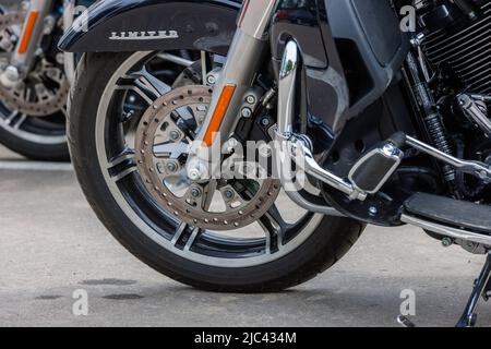 2022 Harley-Davidson Road Glide Limited Motorcycle on asphalt parking at spring day - close side view on front wheel with disc brake in Tula, Russia - Stock Photo
