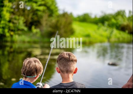 Peaceful fishing. Two male friends fishing together. happy