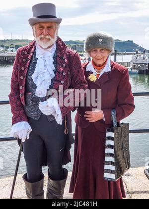 Reenactors portray a 1620 man and woman at the Mayflower Steps in Plymouth, Devon, England, UK. Stock Photo