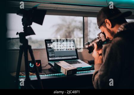 Young photographer working in his office Stock Photo