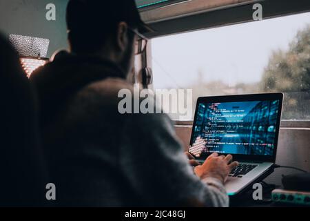 Young man typing on the computer from home Stock Photo