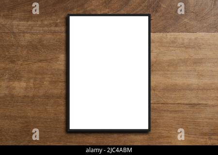 Picture frame on a white wooden wall white frame. Blank Mockup . Stock Photo