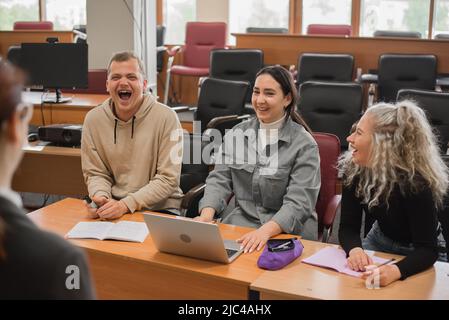 The teacher and students communicate in sign language in the classroom. Hearing impaired and deaf people Stock Photo