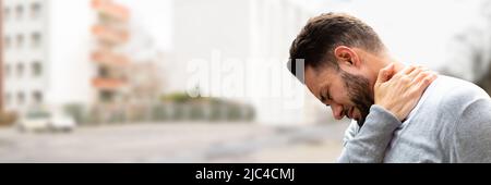 Young Man Having Pain In His Neck Stock Photo