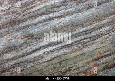 Beautiful wood surface pattern with metallic hues and wavy grey-green diagonal lines. Stock Photo