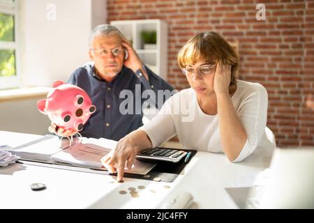 Portrait Of A Couple Sitting On Couch Enjoying Success Stock Photo
