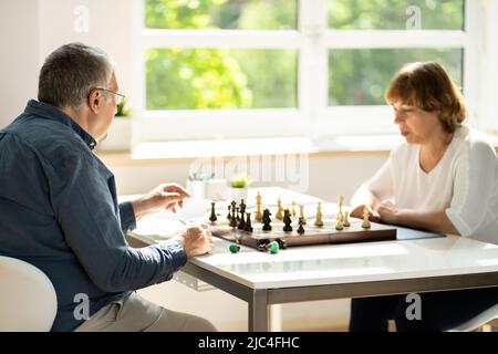 Elderly Senior Playing Chess Table Board Game Stock Photo