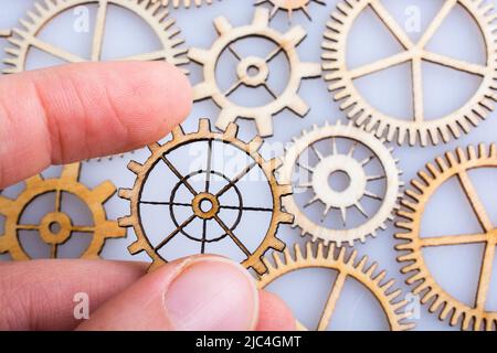 Hand holding gear wheels as the concept of mechanism Stock Photo