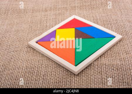 Colorful pieces of a square tangram puzzle Stock Photo