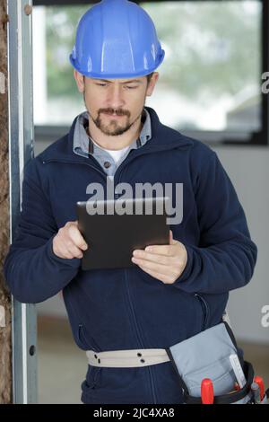 builder with tablet in construction site Stock Photo