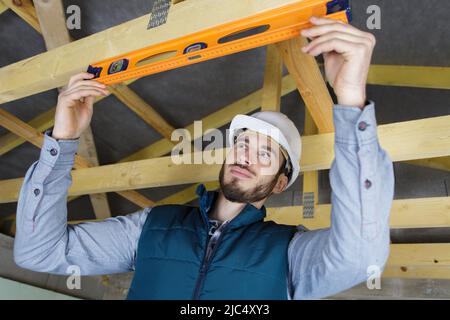 male construction worker adjusting ceiling part Stock Photo