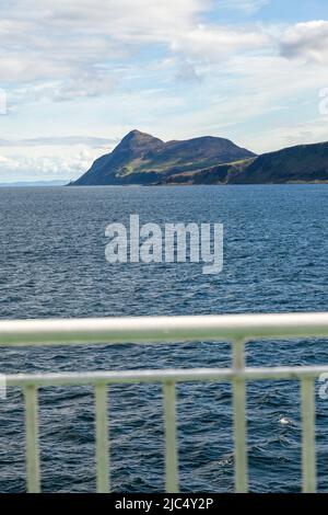 Looking across to the Holy Isle from the ferry leaving Brodick harbour on the Isle of Arran.Its highest point is the hill Mullach Mòr Stock Photo