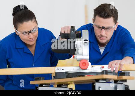 student in carpentry class using circular saw Stock Photo