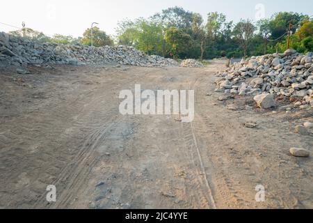 Deforestation and soil digging for constructing a road in the middle of a forest. Dehradun, Uttarakhand India Stock Photo