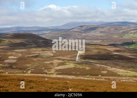 The B976 signle track road passing over heather moors near Balmoral, Aberdeenshire, Scotland Stock Photo
