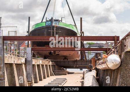 Den Helder, the Netherlands, May 2022. Old-fashioned flat-bottomed ship on the slipway at Willemsoord shipyard in Den Helder. High quality photo Stock Photo