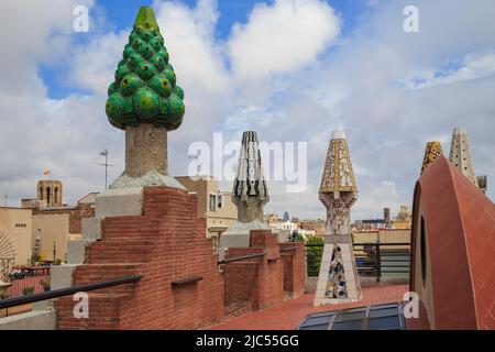 BARCELONA, SPAIN - MAY 10, 2017: These are colorful, ceramic-tiled chimneys of Gaudi's work on the roof of Guell's house. Stock Photo