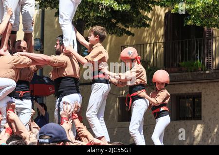 GIRONA, SPAIN - MAY 14, 2017: This is the construction of a tower of people, called castel, during the city the Flower Festival. Stock Photo