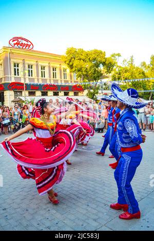 Mexican dancers dressed in stunning colorful bright costumes performing at street procession 23rd International Folklore Festival,Varna Bulgaria 2014 Stock Photo