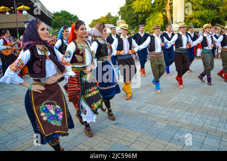 Serbian dancers dressed in traditional costumes performing at street procession of 23rd International Folklore Festival,Varna Bulgaria 2014 Stock Photo
