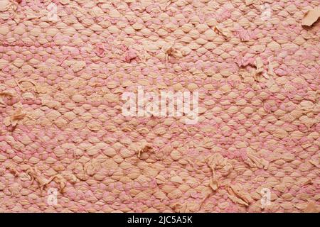 Rag rug close up. Recycled fabric. Pink, white weaved texture Traditional recycled scandinavian carpet. Background. Wallpaper Stock Photo