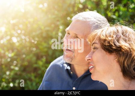Retired Senior Couple Together In Green Outside Stock Photo