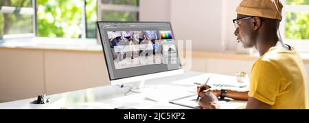 Designer Editing Photo On Computer In Office Stock Photo