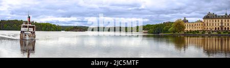 panoramic view across the lake Maelaren with the royal palace Drottningholm and the historic ferryboat Prinse Carl Philip from the year 1901 near Stoc Stock Photo