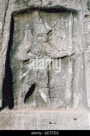 Hittite-Luwian rock relief about 1.5 meter wide and 2.5 meters high and located in a passage between two mountains on the road south to Torbalı at a distance of six kilometers from Kemalpasa center. Archival scan from a slide. October 1985. Stock Photo