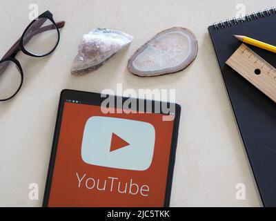 In this photo illustration YouTube logo seen displayed on a tablet Stock Photo