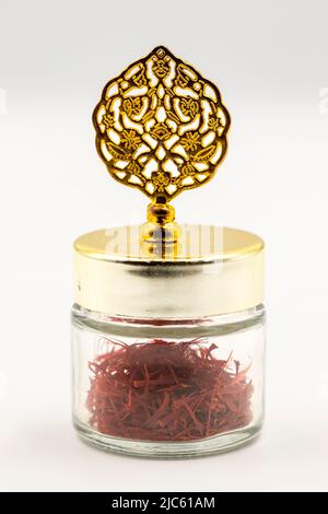 Packaged Iranian saffron in glass bottle on white background. close up Stock Photo