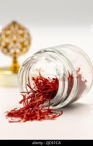 Packaged Iranian saffron in glass bottle on white background. close up Stock Photo