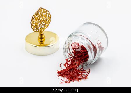 Packaged Iranian saffron in glass bottle on white background. close up Stock Photo