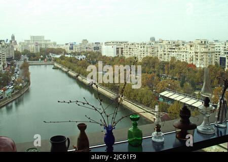 Bucharest, Romania. Dambovita River crossing through Unirii Plaza. The Palace of the Parliament seen in the back. Stock Photo